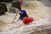 Paddling a river in the Riot Thunder white water kayak